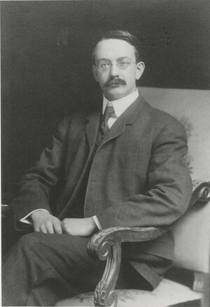 Portrait photograph of Edwin Grant Conklin, dressed in a suit, and seated. The photograph is signed, 'Sincerely yours, Edwin G. Conklin, June 13, 1908'