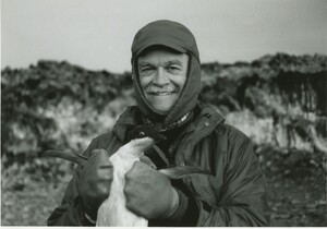 John Hobbie holding a penguin
